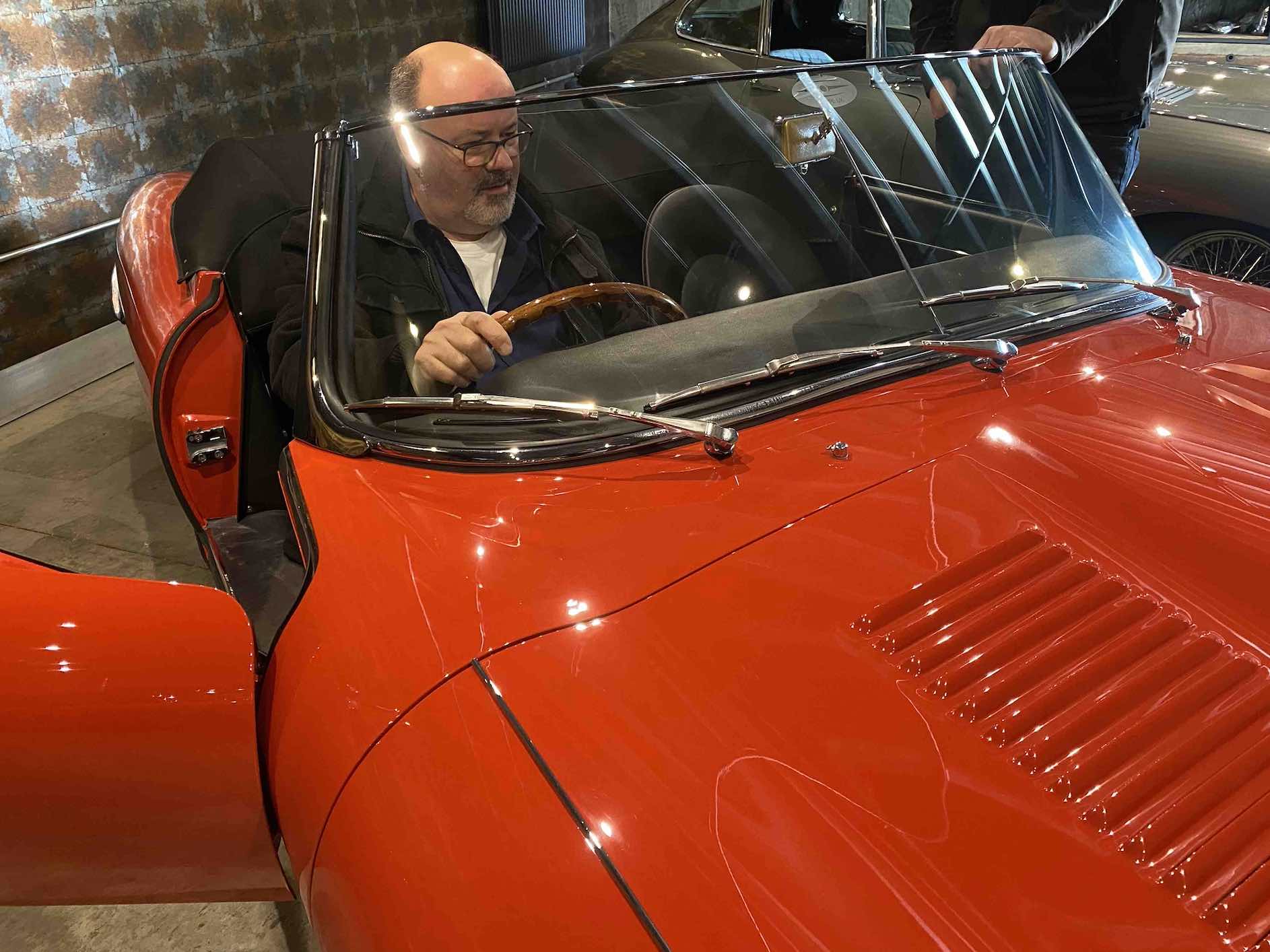 Author TNA Howe in the seat of a classic Jaguar E-Type