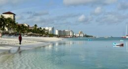 Palm Beach Aruba with woman walking on beach