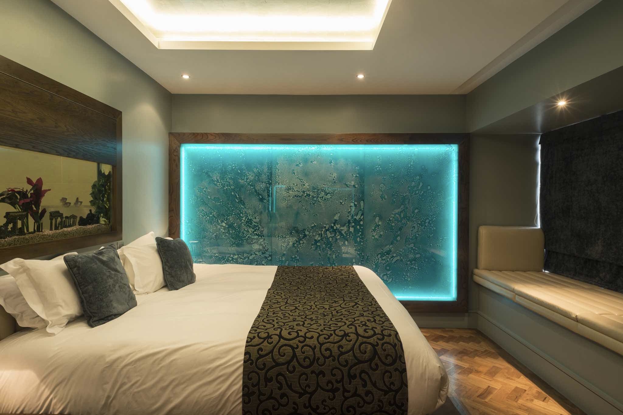 Le Monde Hotel bedroom with blue lighting at one of the best luxury boutique hotels in Edinburgh